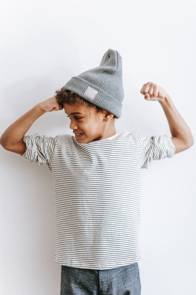 stylish black boy with arms bent in elbows